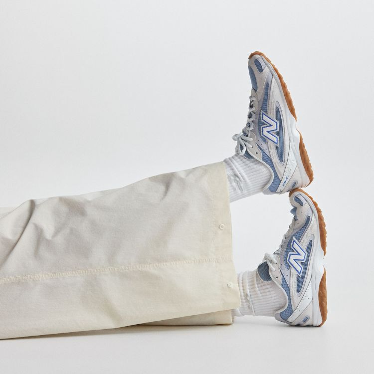 Person sitting in a chair wearing new balance shoes